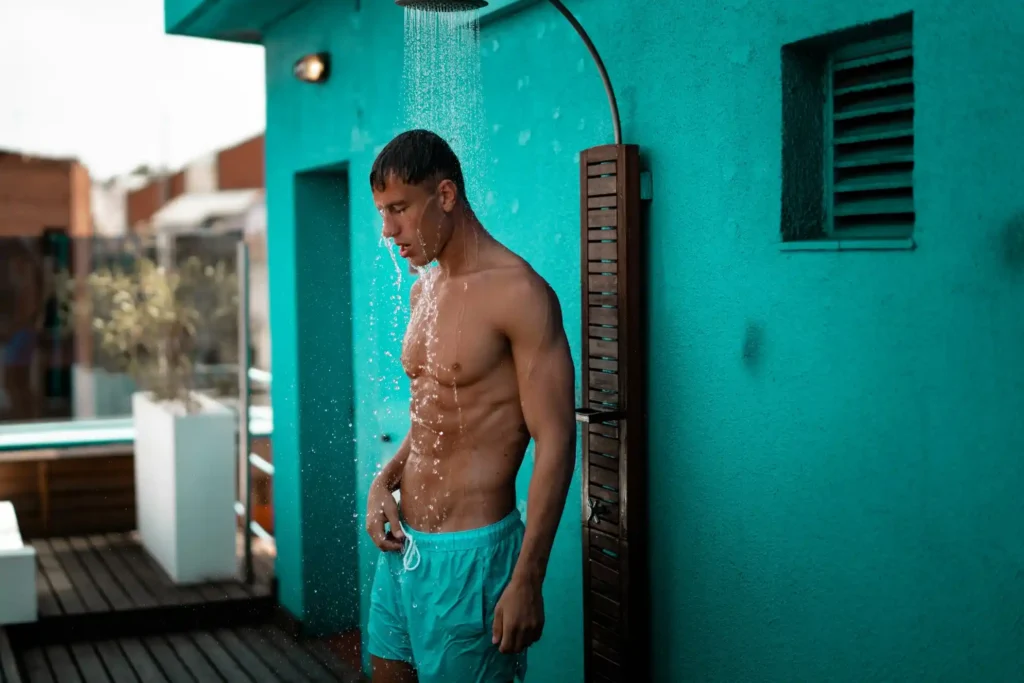 Man showering outdoors on a sunny day