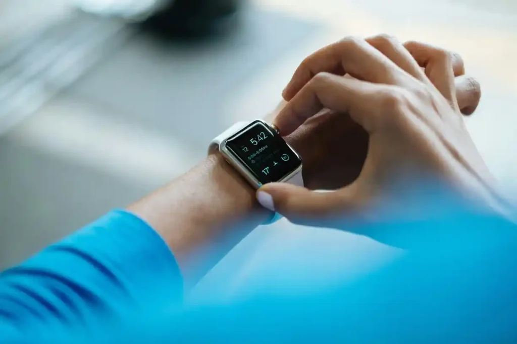 Person using smartwatch for notifications and time.