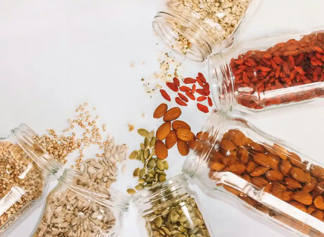 Assorted nuts and seeds in glass jars.